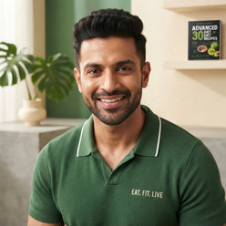 Ankit Sharma, fitness influencer, smiling confidently in a professional headshot against a soft-toned, clean studio backgroun