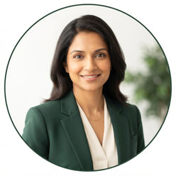 Dr. Meera Rao, a nutrition expert, smiling warmly in a professional portrait against a bright, clean background.